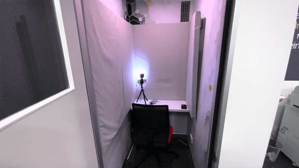 A basic YouTube studio filming setup in a call room in a co-working space